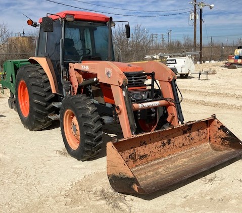 a large tractor parked in the dirt