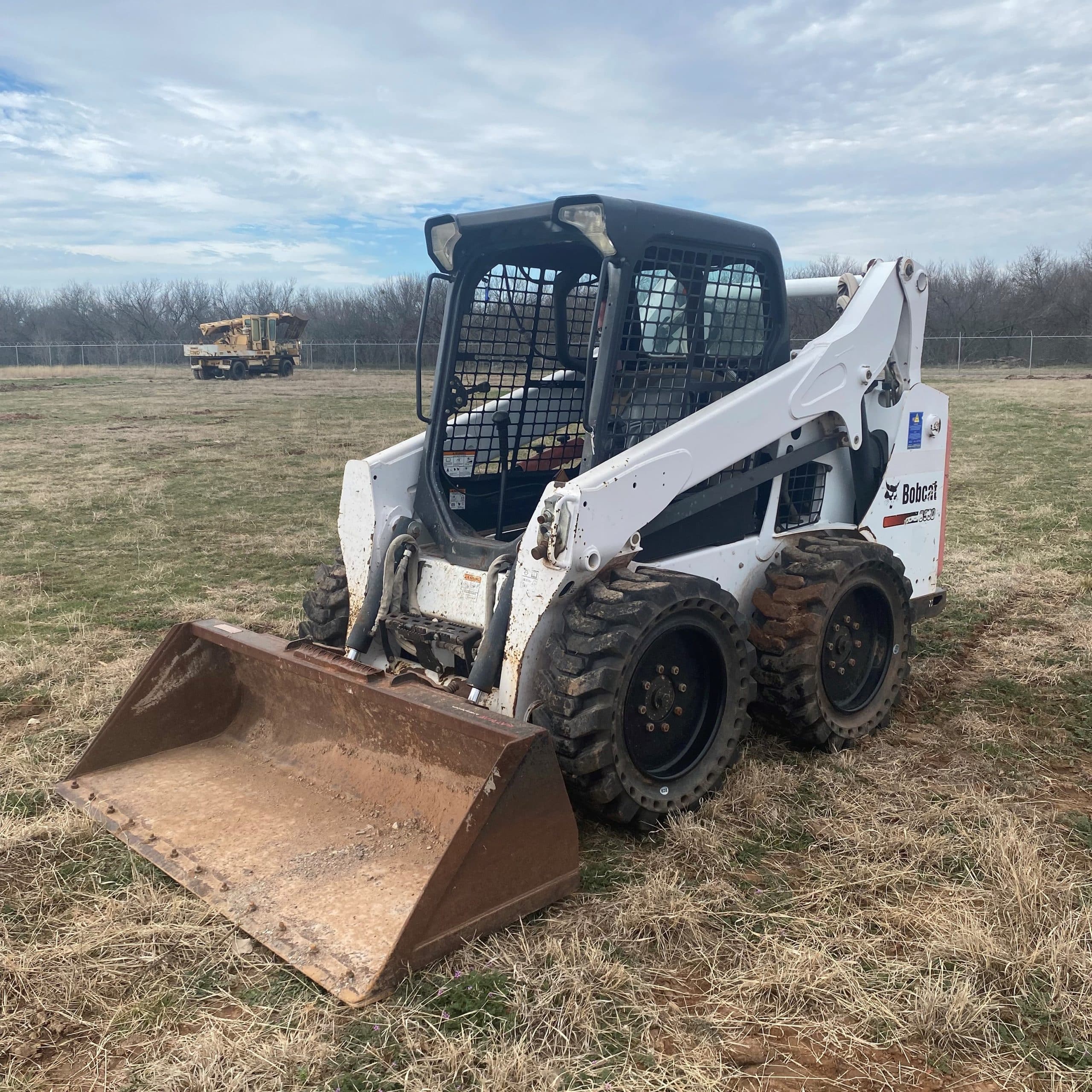 A Tractor In A Dirt Field