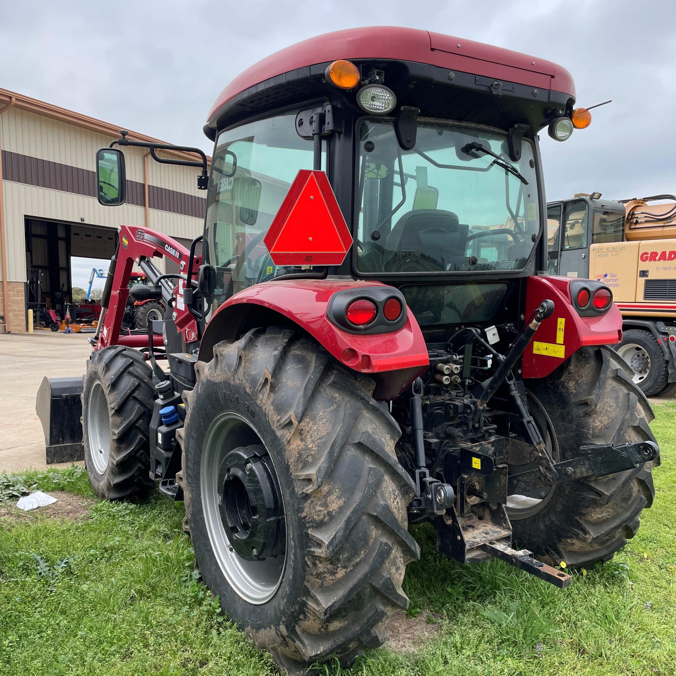 A Large Tractor Parked In The Grass
