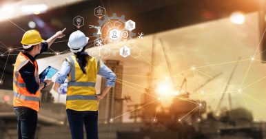 Two construction workers in neon vests overlooking a construction site with futuristic icons overlaid.