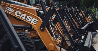 Brand new orange CASE machines all lined up for sale at ASCO Equipment’s location in Texas.