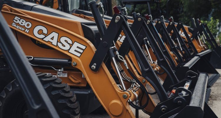 Brand new orange CASE machines all lined up for sale at ASCO Equipment’s location in Texas.